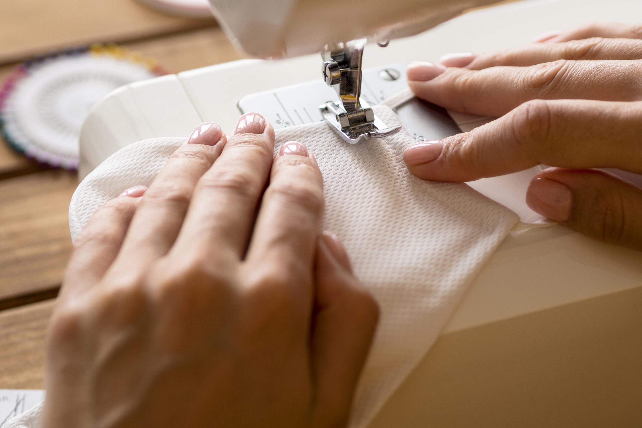 Best Custom Apparel in Garment Hub Delhi, New Delhi Delhi high angle woman using sewing machine face mask